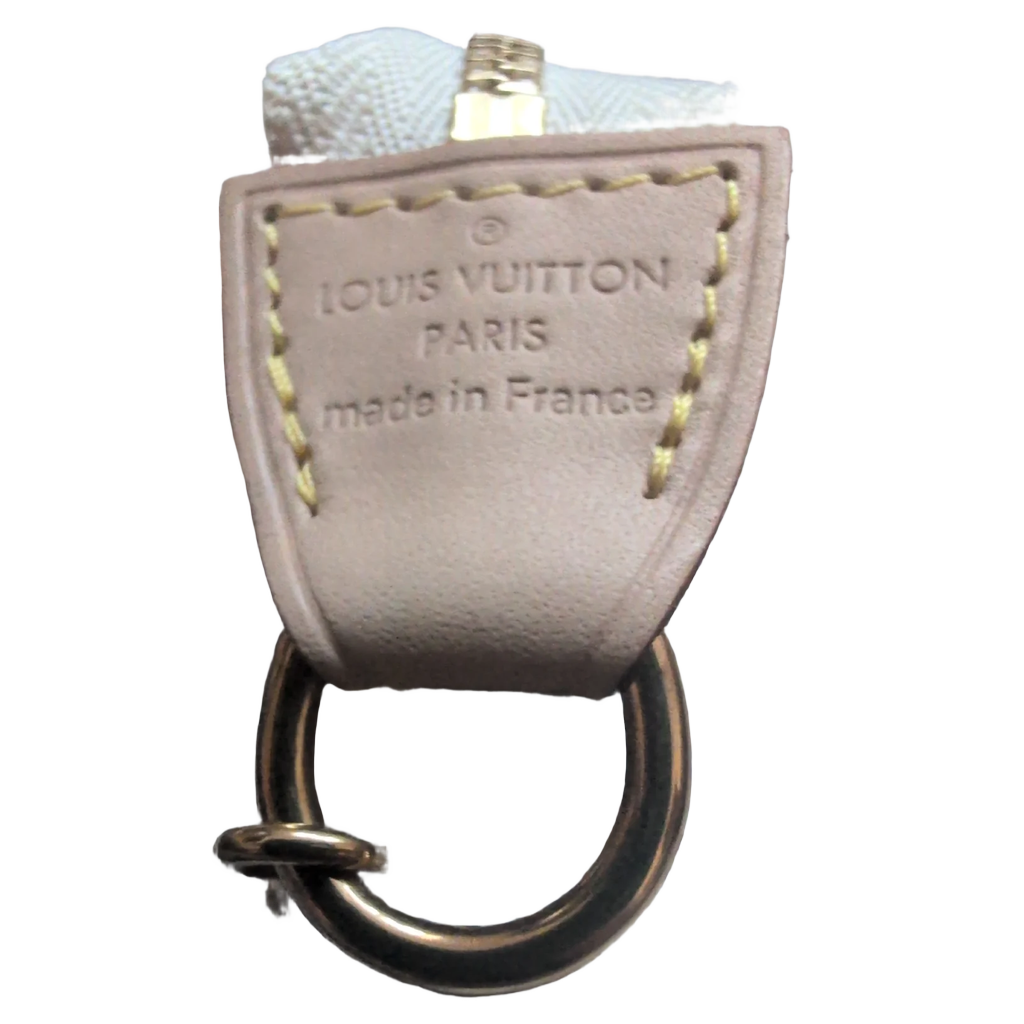 Clos eup of leather showing Pre-owned Louis Vuitton Mini Pochette Damier AZUR Canvas branding