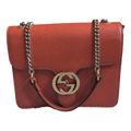 front of Orange Gucci GG Interlocking Crossbody Bag 