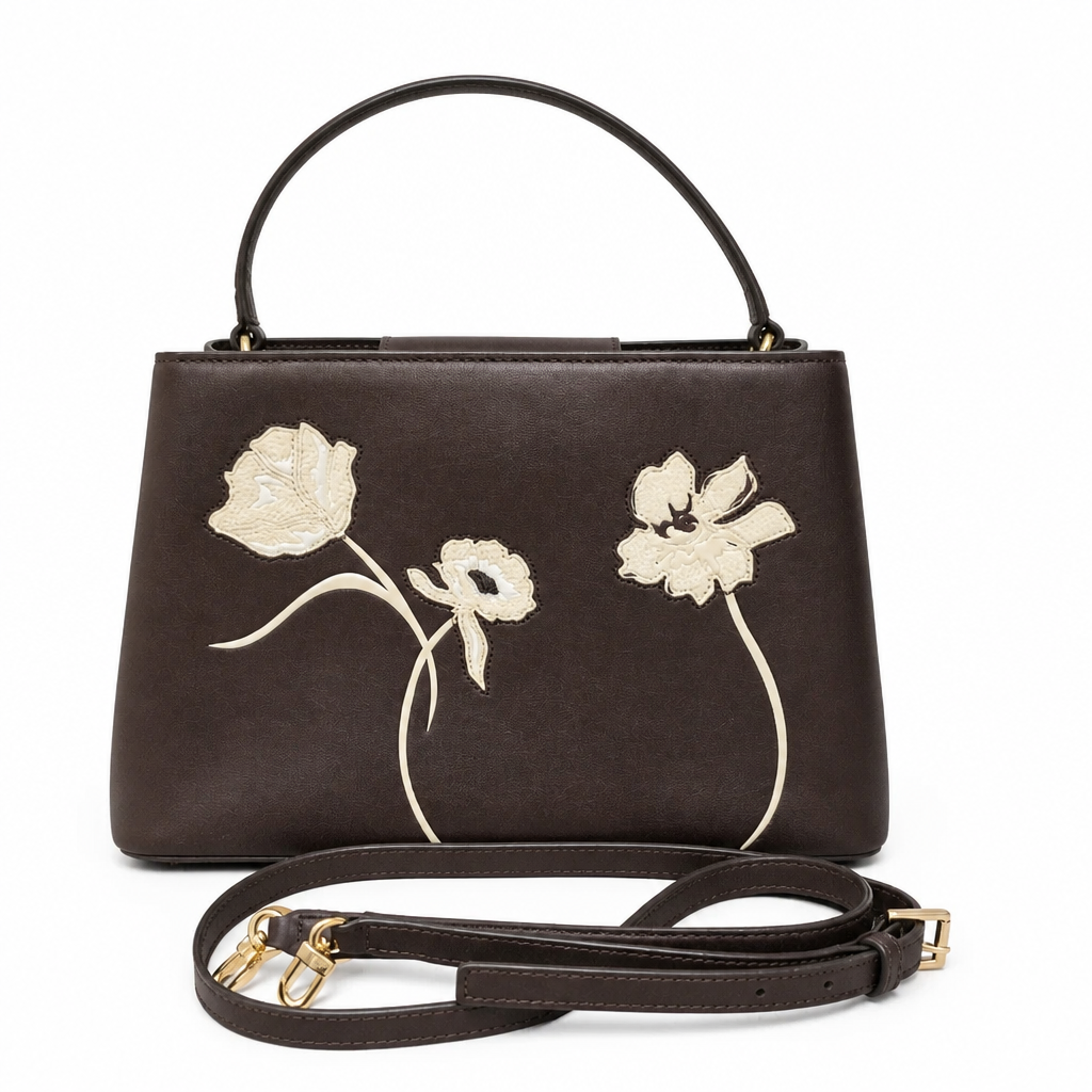 A dark brown leather handbag with a top handle and detachable shoulder strap, featuring large cream-colored embroidered poppy flowers on the front, set against a plain white background. Pre-Owned Tory Burch  Floral Applique Top Handle Bag