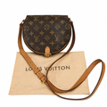 Louis Vuitton monogram canvas half-moon shoulder bag with tan leather trim and strap, displayed on top of a beige Louis Vuitton dust bag against a white background. Pre-Owned Louis Vuitton Monogram Tambourin Shoulder / Crossbody Bag