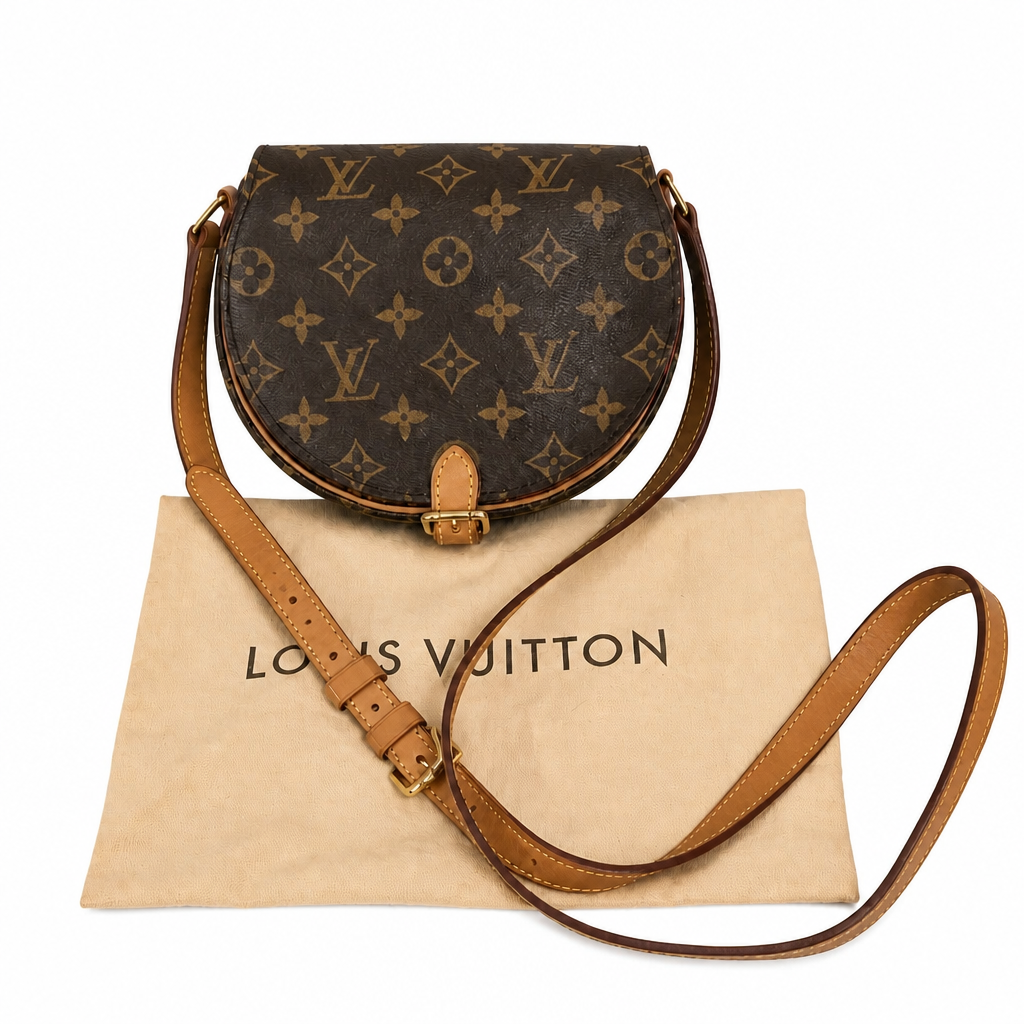 Louis Vuitton monogram canvas half-moon shoulder bag with tan leather trim and strap, displayed on top of a beige Louis Vuitton dust bag against a white background. Pre-Owned Louis Vuitton Monogram Tambourin Shoulder / Crossbody Bag