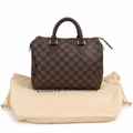 A Louis Vuitton handbag in the Damier Ebene checkered pattern, displayed on top of its beige dust bag against a white background. Pre-Owned Louis Vuitton Speedy 25 in classic Damier Ebene coated canvas
