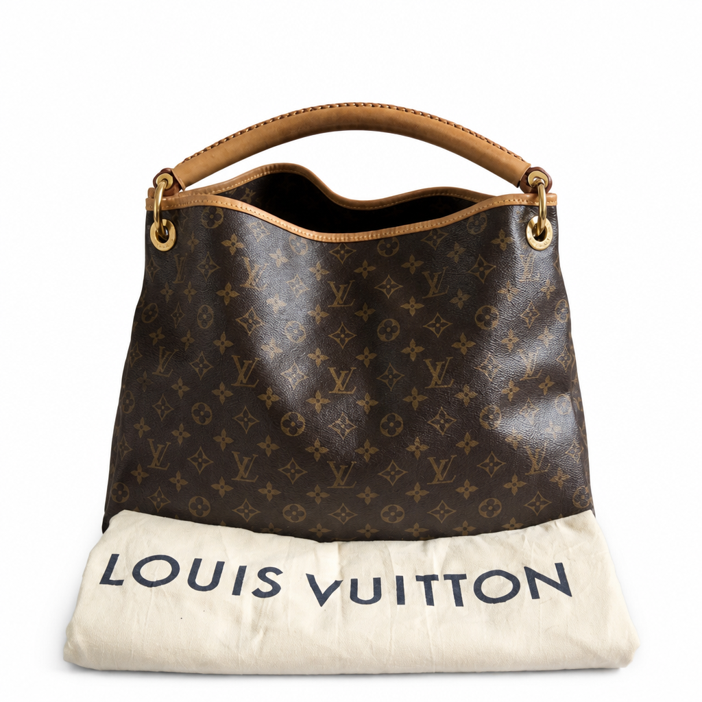 A Louis Vuitton monogram canvas shoulder bag with tan leather trim and handle, displayed above a cream-colored Louis Vuitton dust bag on a white background. Pre-Owned Louis Vuitton Artsy MM Monogram Canvas Shoulder Bag 