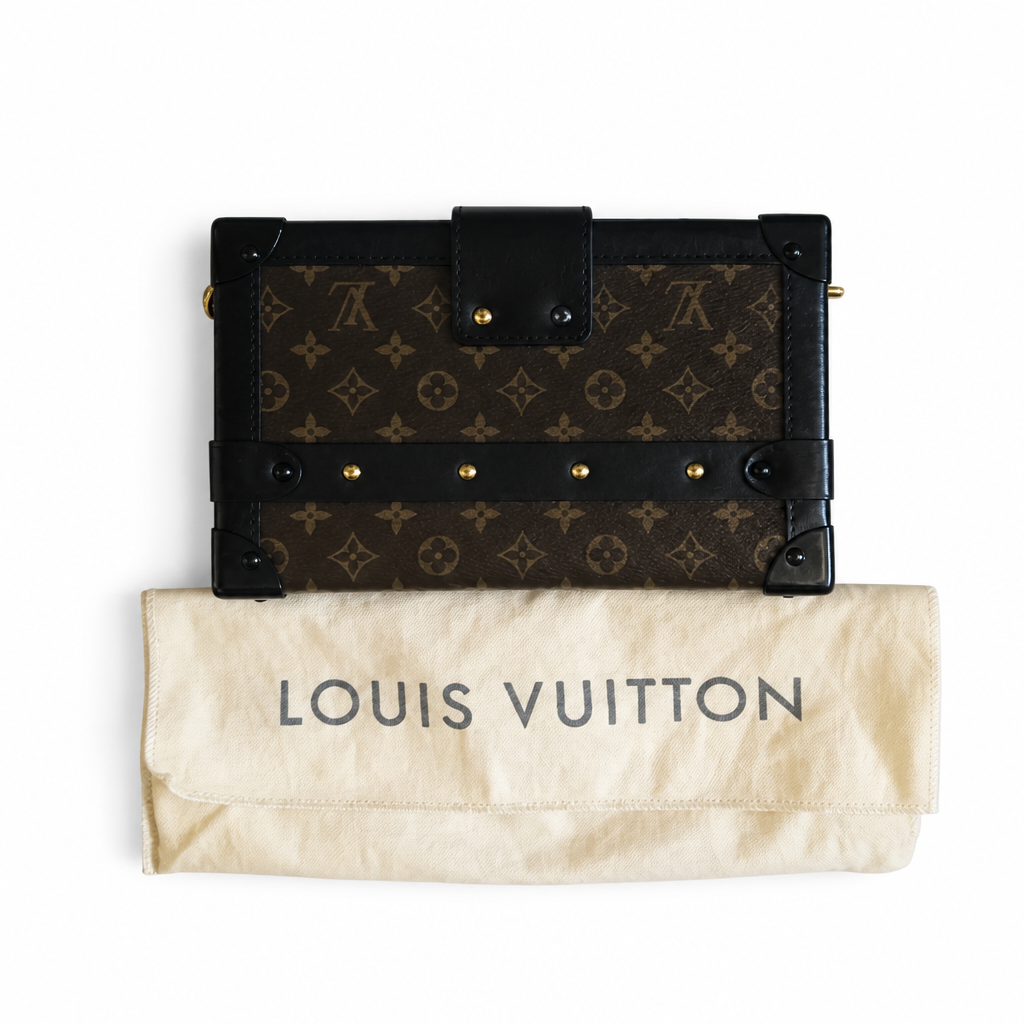 A Louis Vuitton monogram canvas and leather journal-style notebook cover shown next to its cream-colored dust bag with 'LOUIS VUITTON' printed vertically, on a clean white background. Pre-Owned Louis Vuitton Petite Malle Monogram Canvas Crossbody Bag