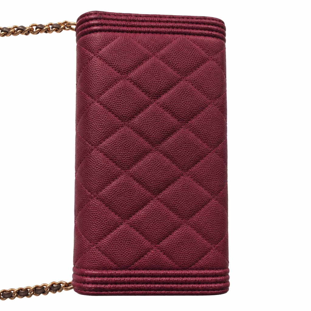A burgundy quilted leather pouch with a diamond pattern, featuring a gold chain strap, shown against a plain white background. Pre-Owned Chanel Boy Wallet on Chain – Fuchsia Pink Caviar Leather – Gold Hardware