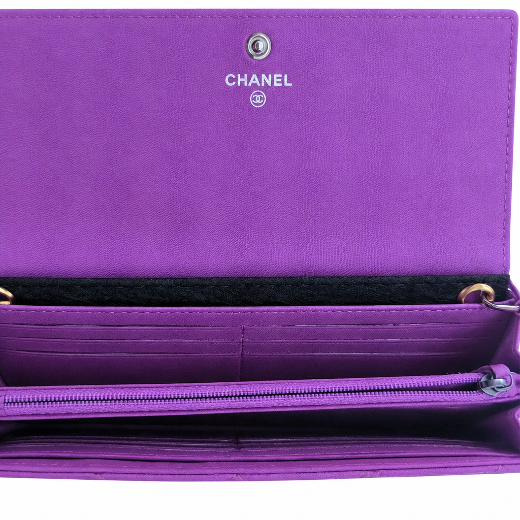 Purple Chanel wallet shown open, featuring the silver CHANEL logo and interlocking CC emblem on the inside flap, multiple card slots, and a zip compartment. Pre-Owned Chanel Quilted Wallet on Chain WOC – Pink/Purple Lambskin – Silver Hardware