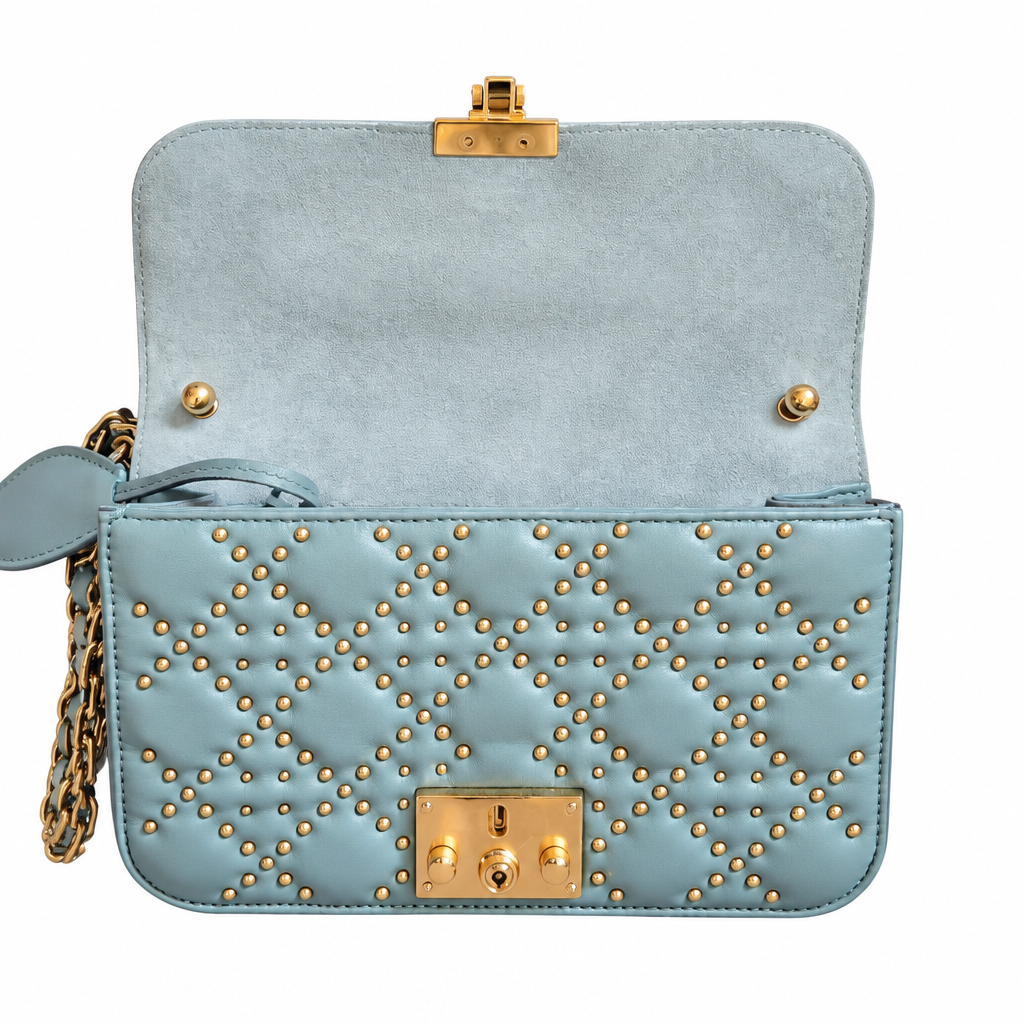 A light blue leather handbag with gold-tone hardware, featuring a quilted diamond pattern on the front flap, a matching blue suede interior, and a gold clasp closure, shown against a plain white background. Pre-Owned Christian Dior Small DiorAddict Cannage Studded Flap Bag – Light Blue Lambskin