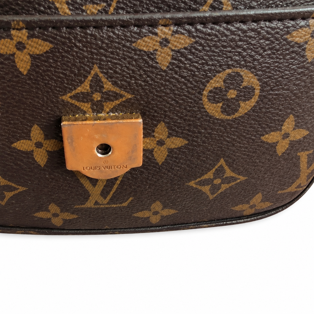 Close-up of a Louis Vuitton monogram bag in brown coated canvas with tan monogram motifs and a brass-tone turn-lock clasp on a white background. Pre-Owned Louis Vuitton Passy Monogram Shoulder Bag – Burgundy Interior