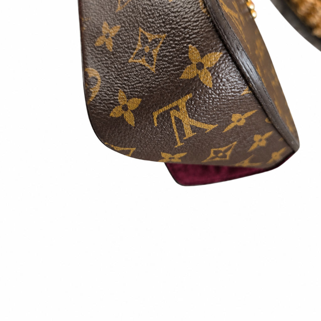 Close-up of a brown Louis Vuitton monogram canvas bag corner showing the classic tan LV logo and floral motifs, with a dark brown leather trim and a hint of a burgundy interior lining against a white background. Pre-Owned Louis Vuitton Passy Monogram Shoulder Bag – Burgundy Interior