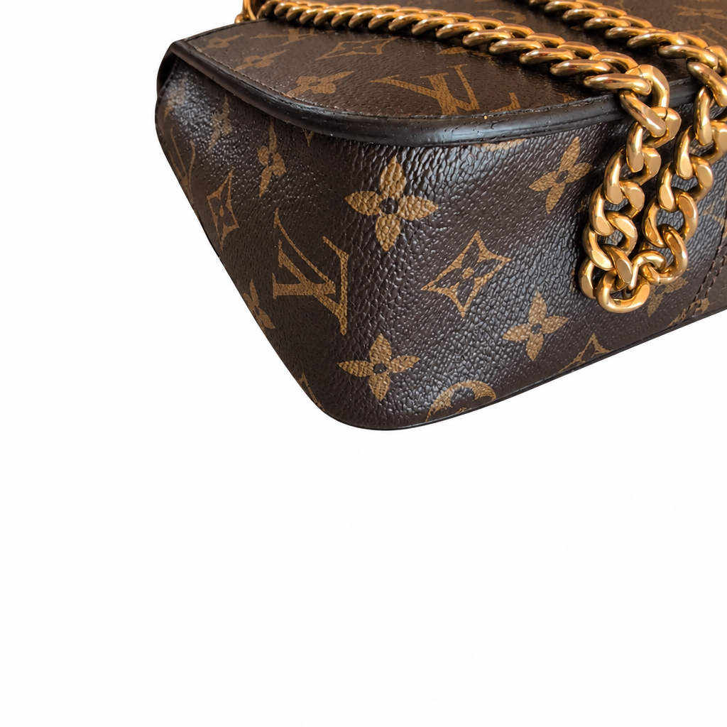 Close-up of a Louis Vuitton handbag in brown monogram canvas with a gold chain strap on a white background. Pre-Owned Louis Vuitton Passy Monogram Shoulder Bag – Burgundy Interior