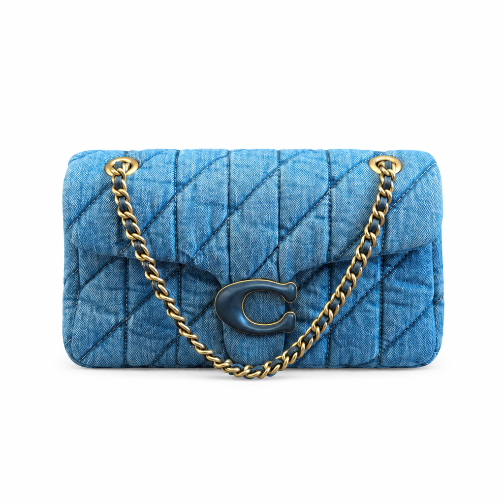 A blue quilted denim shoulder bag with a gold-tone chain strap and a dark blue 'C' logo clasp on a white background. Pre-Owned Coach Quilted Tabby Shoulder Bag 26 – Blue Denim