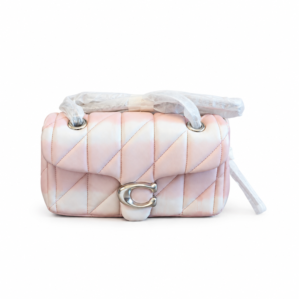 A small quilted shoulder bag in a soft pink and white ombre pattern, featuring a silver-tone C-shaped turn-lock closure and a white leather strap wrapped in protective plastic. Pre-Owned Coach Tabby 20 Quilted Nappa Leather Shoulder Bag – Pink & White Ombré