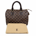 A Louis Vuitton Speedy bag in Damier Ebene canvas with dark brown leather handles and trim, shown with its beige dust bag in front on a white background. Pre-Owned Louis Vuitton Speedy 25 Damier Ebene Coated Canvas Bag DU4151