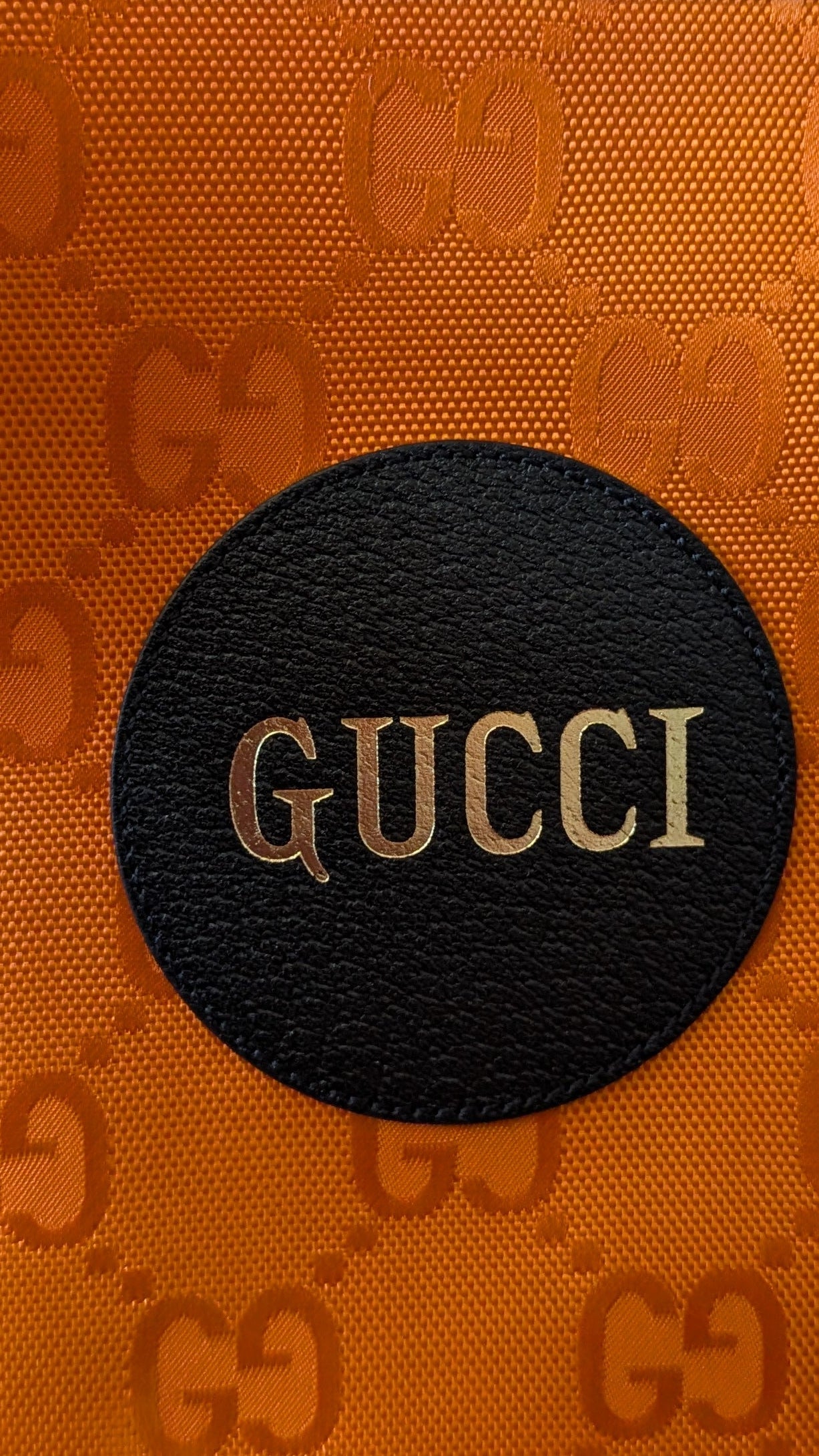 close up of canvas abx Gucci logo on  Pre-owned Gucci Off The Grid High Orange Nylon Clutch Bag
