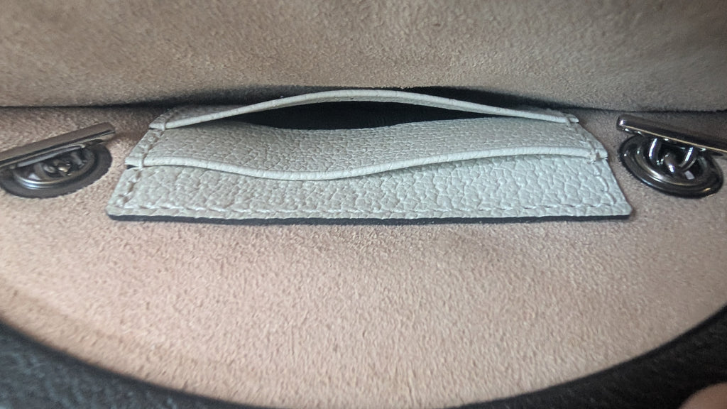 Close up of the internal pocket of the Pre-owned Gucci Strawberry Cross Body Bag Black & White
