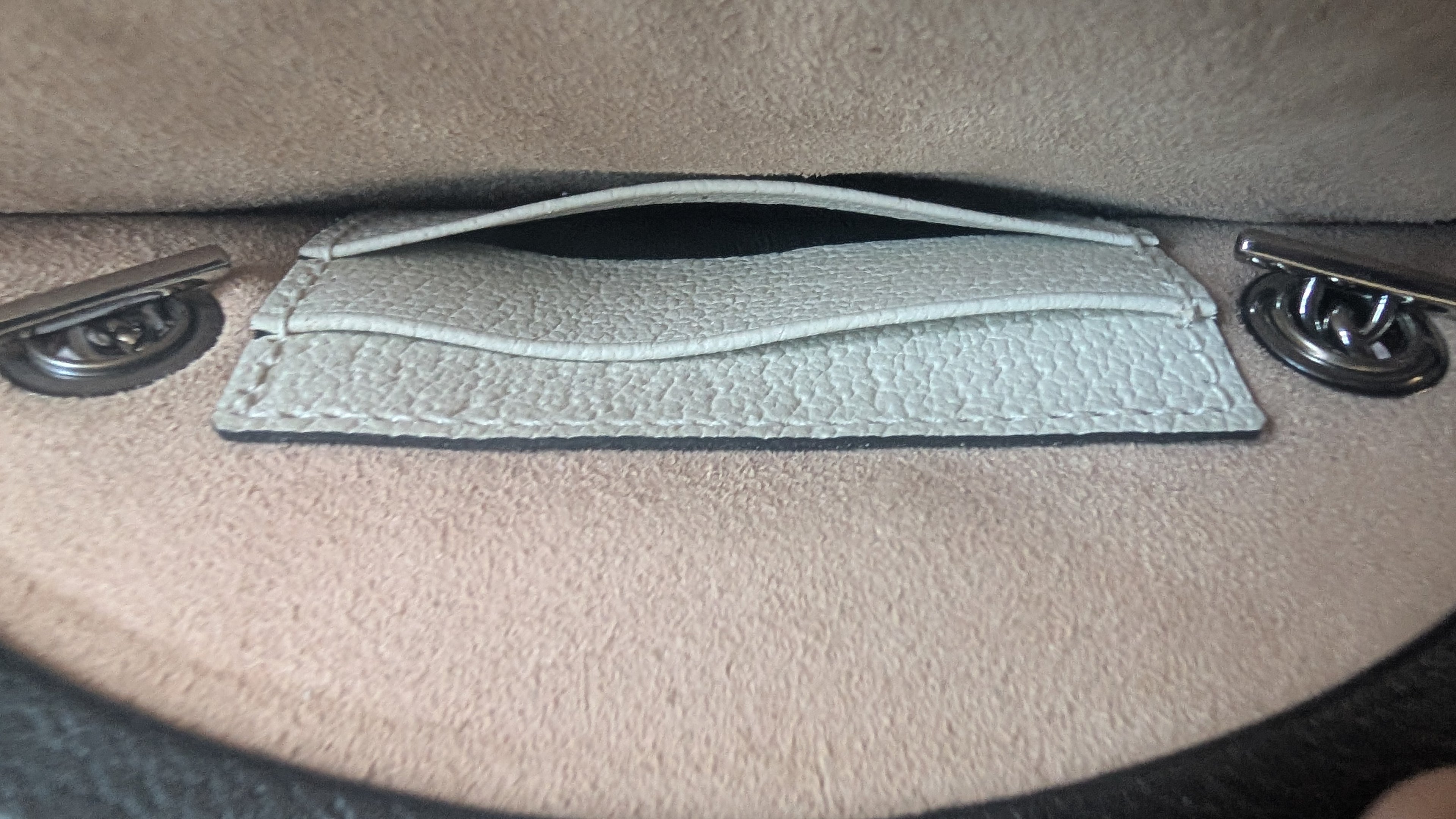 Close up of the internal pocket of the Pre-owned Gucci Strawberry Cross Body Bag Black & White