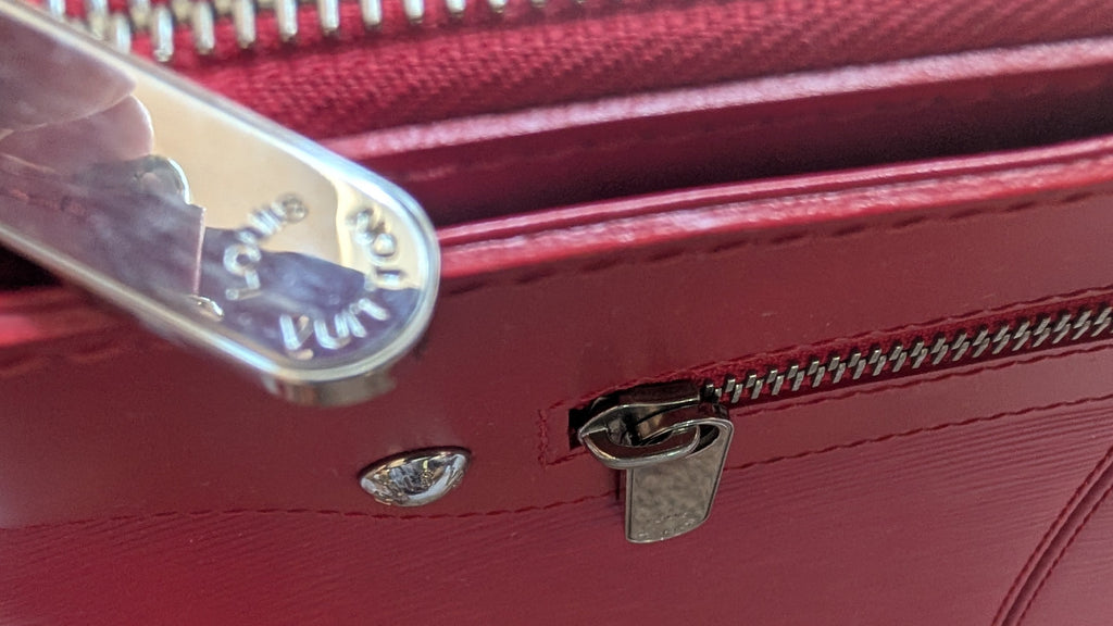 cloae up of Pre-owned LOUIS VUITTON Rouge Epi Leather Turenne Bag zip