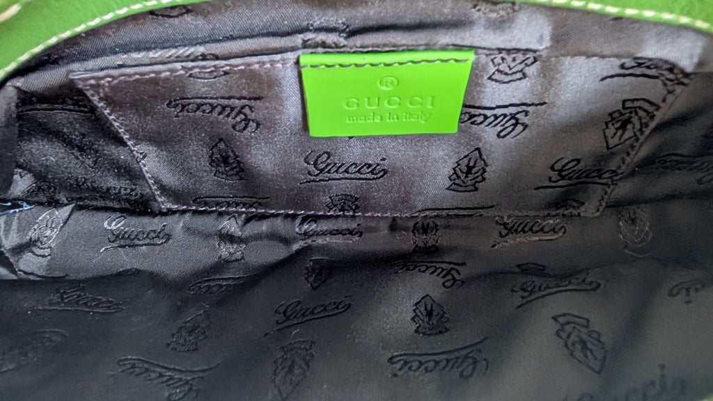 inside of Pre-owned Gucci Green & Black Clutch Snake Print showing gucci logo 
