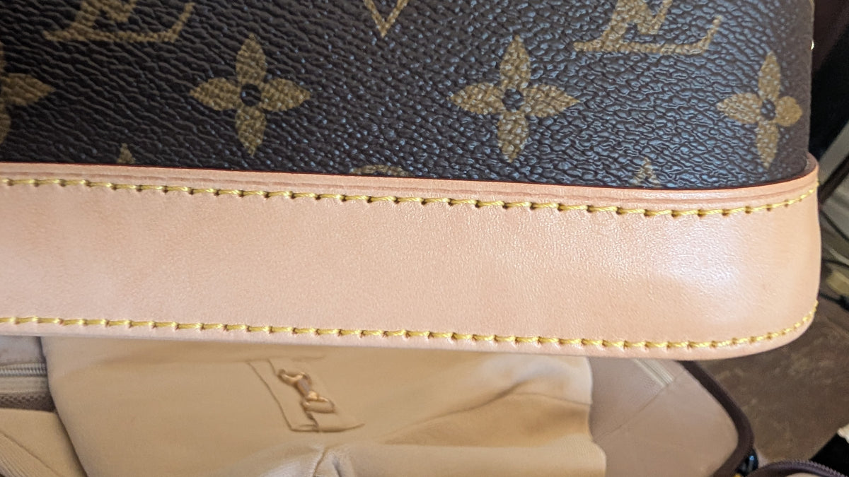close up of edge Pre-Owned Louis Vuitton Alma BB Monogram World Tour / Travel Sticker Shoulder Bag