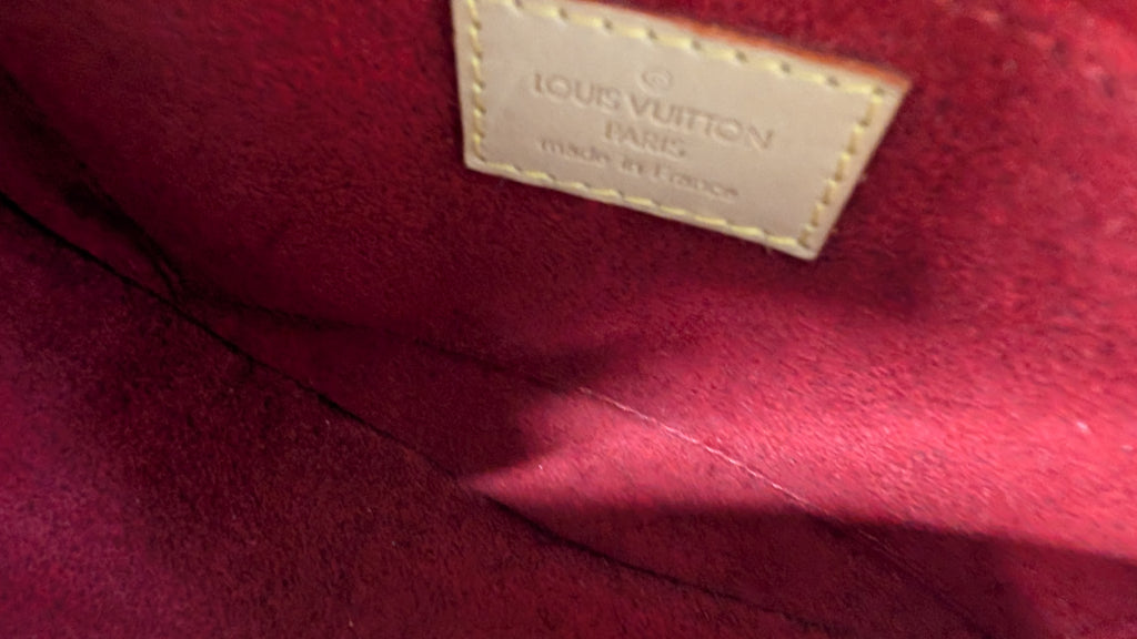 Close-up of a Louis Vuitton interior label stitched onto a deep burgundy suede or velvet surface. Pre-Owned Louis Vuitton Monogram Tambourin Shoulder / Crossbody Bag