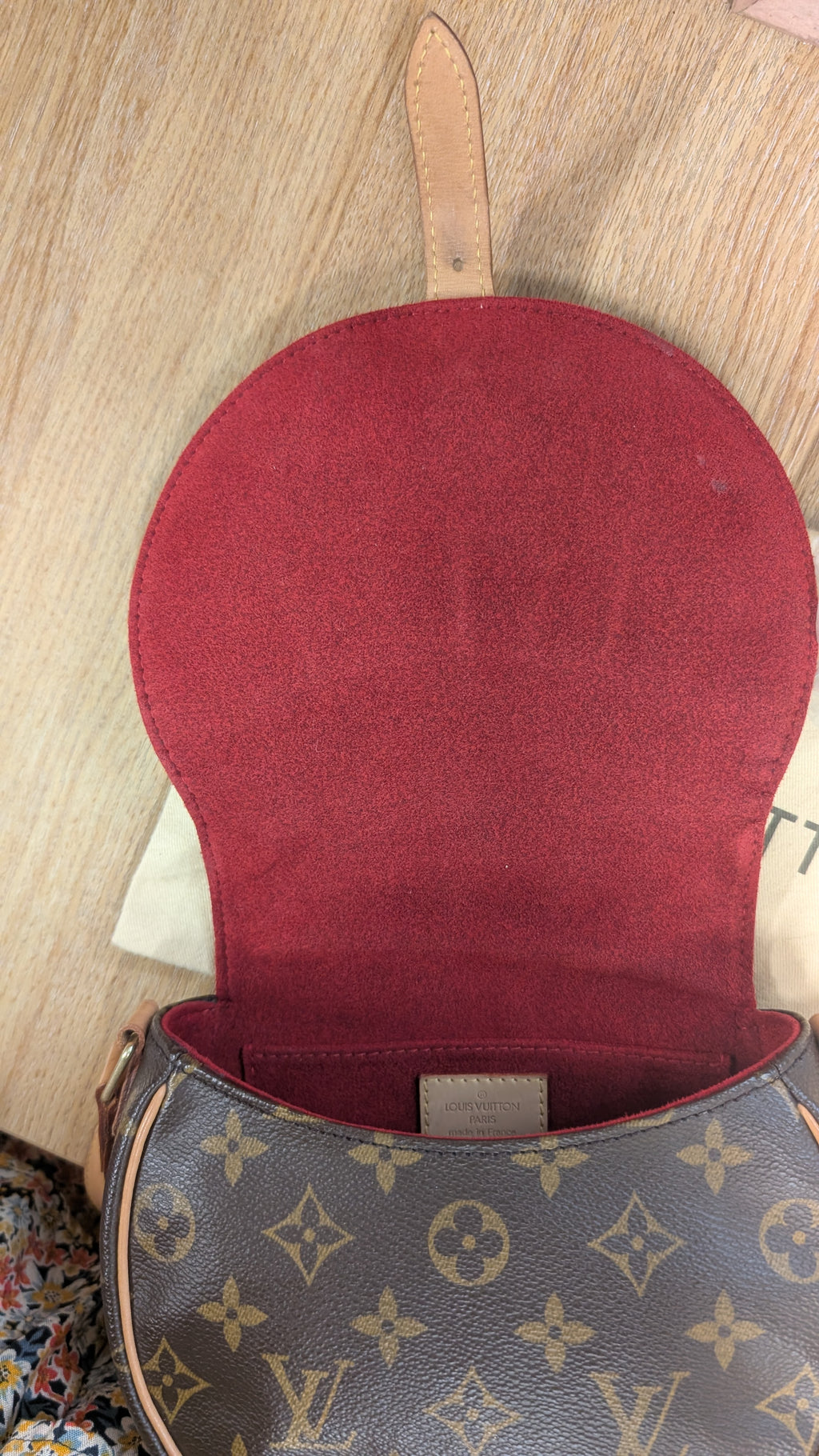 A Louis Vuitton shoulder bag in classic brown monogram canvas, shown open to reveal a deep burgundy red suede interior lining. The iconic LV monogram pattern is visible on the exterior canvas. Pre-Owned Louis Vuitton Monogram Tambourin Shoulder / Crossbody Bag
