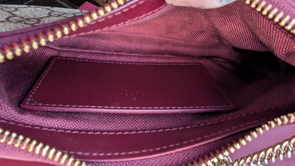 Close-up of the interior of a burgundy canvas handbag, showing a matching burgundy leather cardholder pocket stitched into the lining, gold-tone zipper trim, and a Gucci monogram pattern visible on the upper left corner. Pre-Owned Gucci GG Supreme Ophidia Panda Mini Chain Shoulder Bag