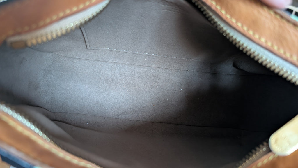Close-up view of the interior lining of a brown leather bag, showing a dark gray suede or velvet insert and gold-toned zipper teeth. Pre-Owned Louis Vuitton Takashi Murakami Lodge PM Shoulder Bag