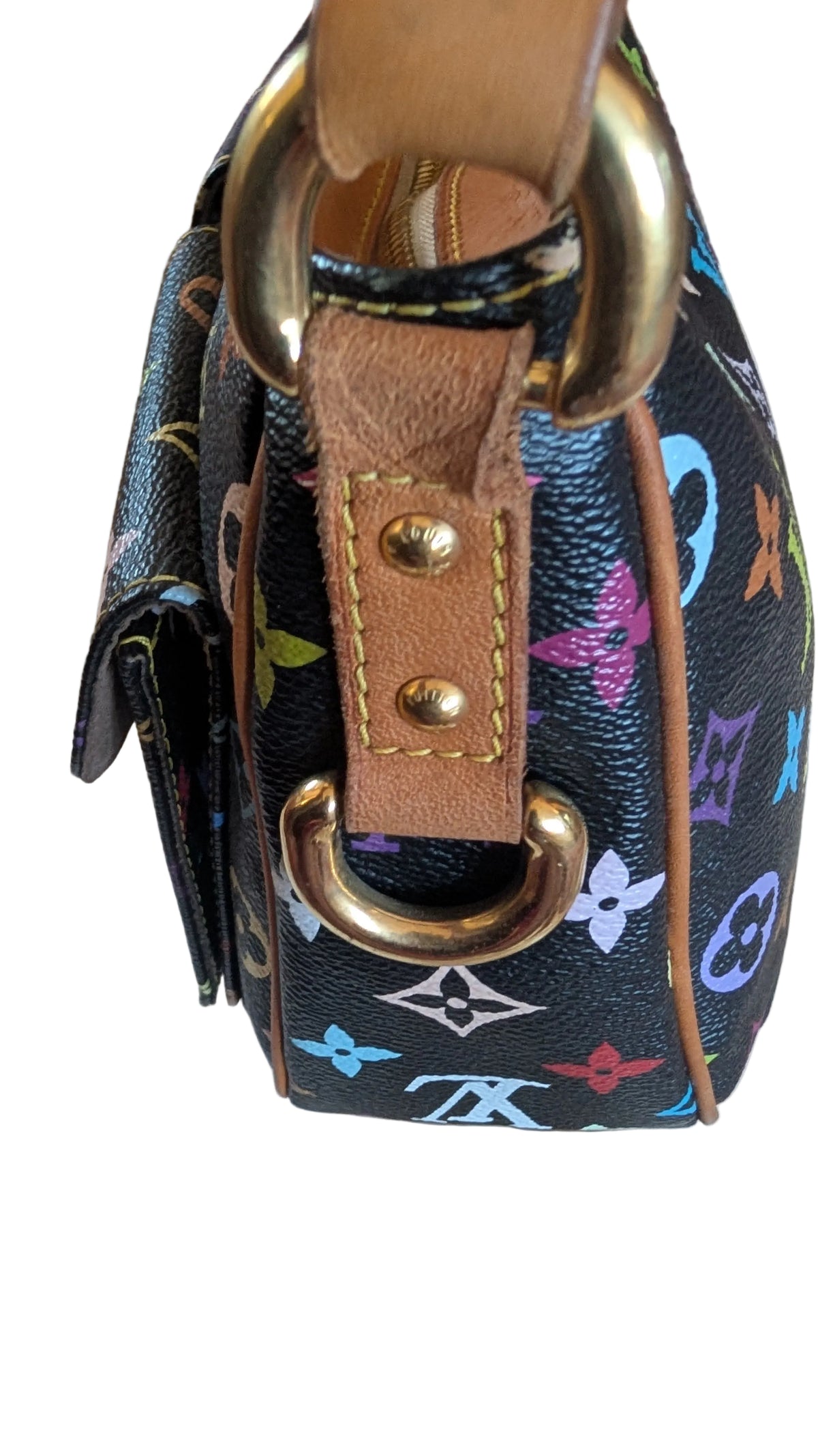 Close-up of a Louis Vuitton handbag in black monogram canvas with colorful floral motifs, tan leather trim, and gold-tone hardware, resting on a light fabric surface. Pre-Owned Louis Vuitton Takashi Murakami Lodge PM Shoulder Bag