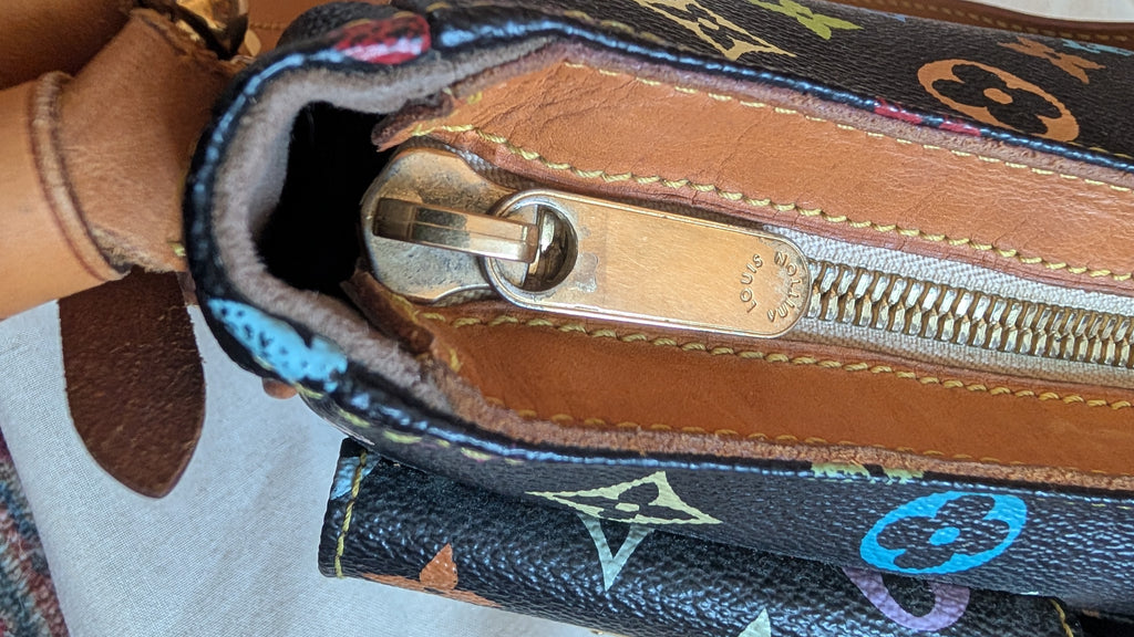 Close-up of a Louis Vuitton monogram bag showing the interior zipper with a brass pull and tan leather lining. Pre-Owned Louis Vuitton Takashi Murakami Lodge PM Shoulder Bag