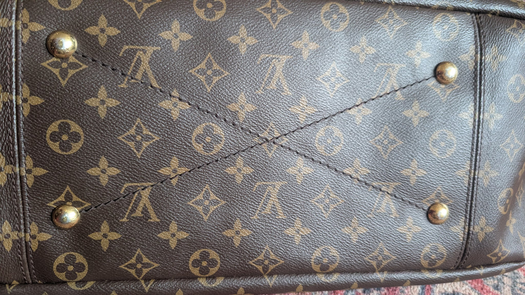 Close-up of a Louis Vuitton monogram canvas bag, showing the classic brown and tan pattern with brass-tone metal studs. Pre-Owned Louis Vuitton Artsy MM Monogram Canvas Shoulder Bag 