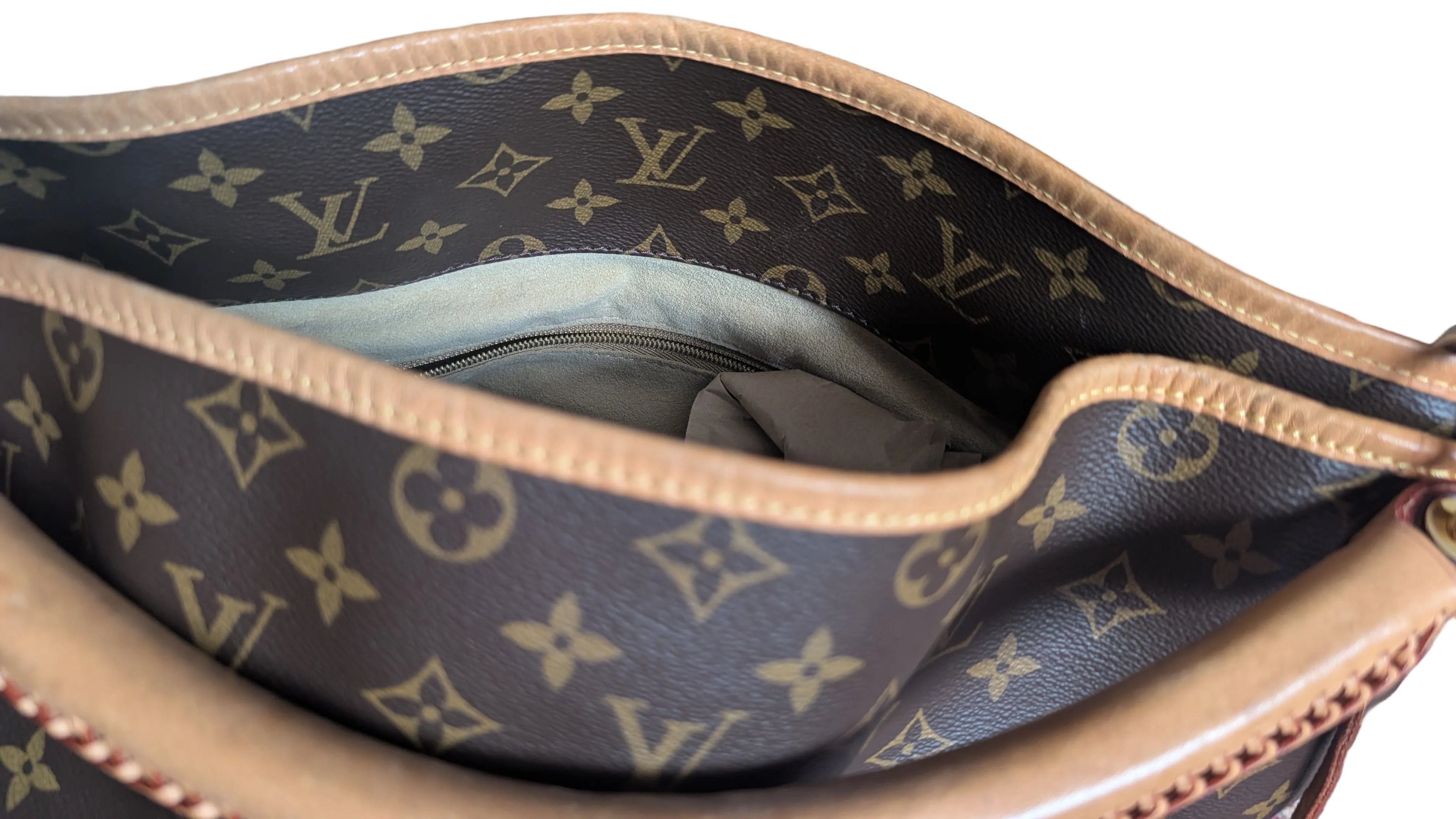 Close-up of an open Louis Vuitton monogram handbag showing the interior lining, tan leather trim, and the classic brown canvas with gold monogram print. Pre-Owned Louis Vuitton Artsy MM Monogram Canvas Shoulder Bag 
