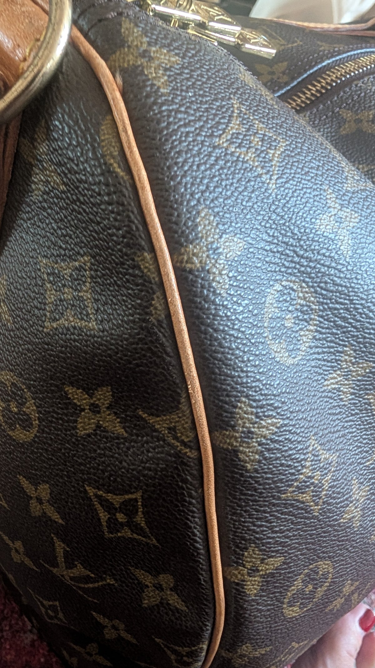 Close-up of a Louis Vuitton monogram canvas handbag in dark brown with tan leather trim and gold-tone hardware. Pre-Owned Louis Vuitton Keepall Bandoulière 60 Monogram Travel Bag