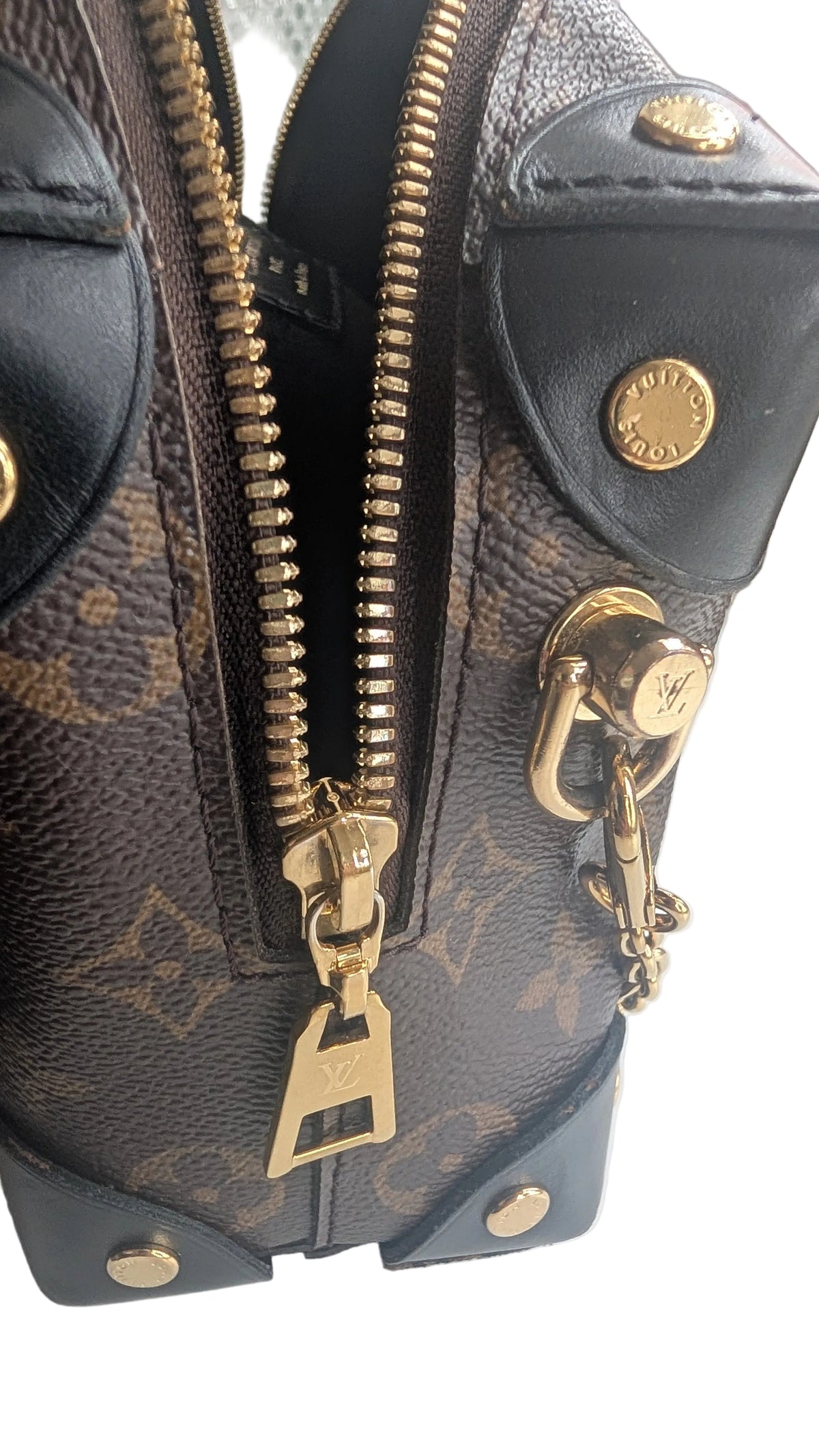 Close-up of a Louis Vuitton monogram canvas and black leather bag with gold-tone zippers, studs, and hardware. Pre-Owned Louis Vuitton Petite Malle Souple Monogram Bag