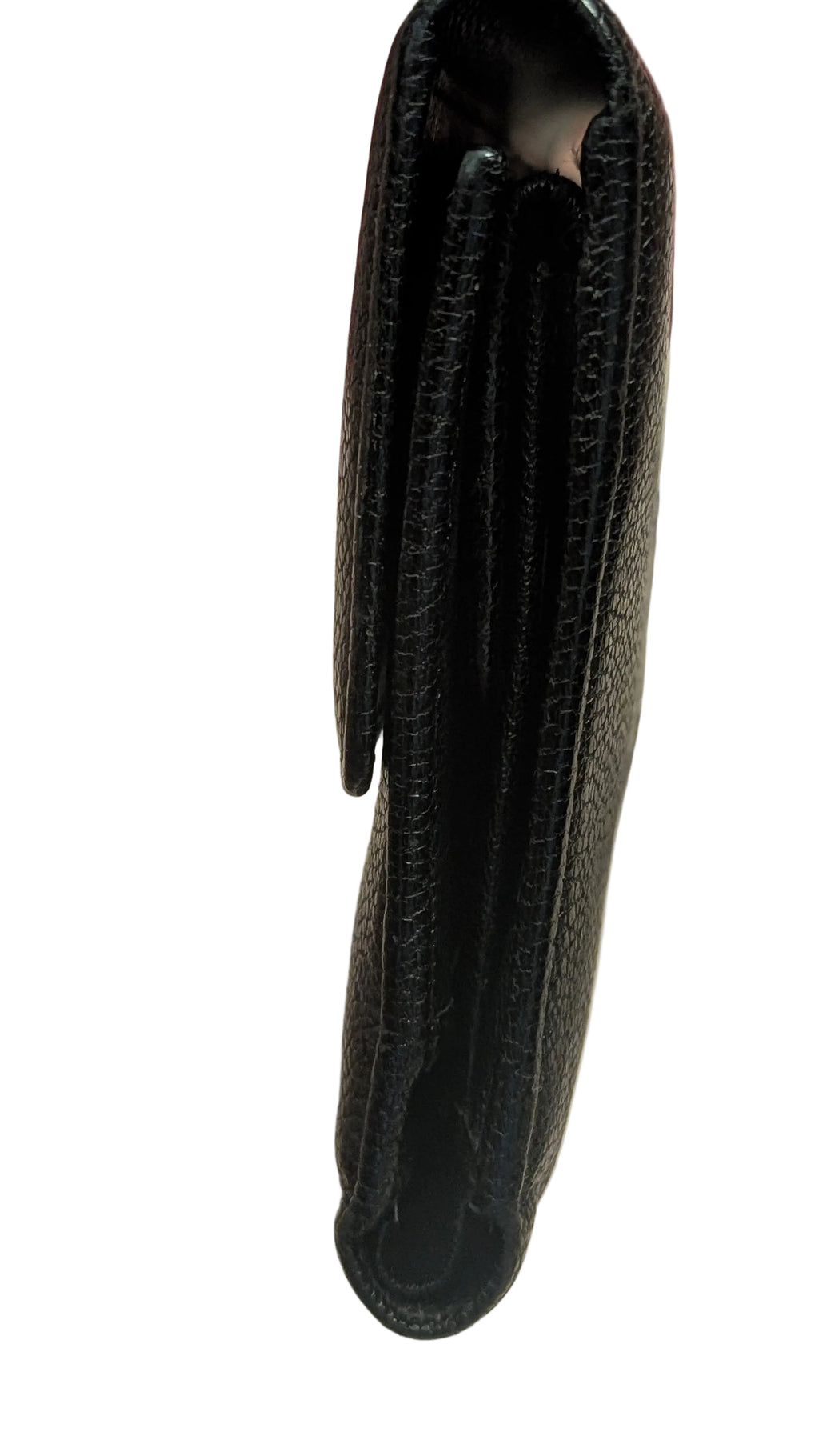 A close-up of a black textured leather wallet being held by a hand, showing the side profile and interior compartments. A silver chain is visible in the blurred background. Pre-Owned Chanel Vintage Black Caviar Leather Wallet with Added Chain