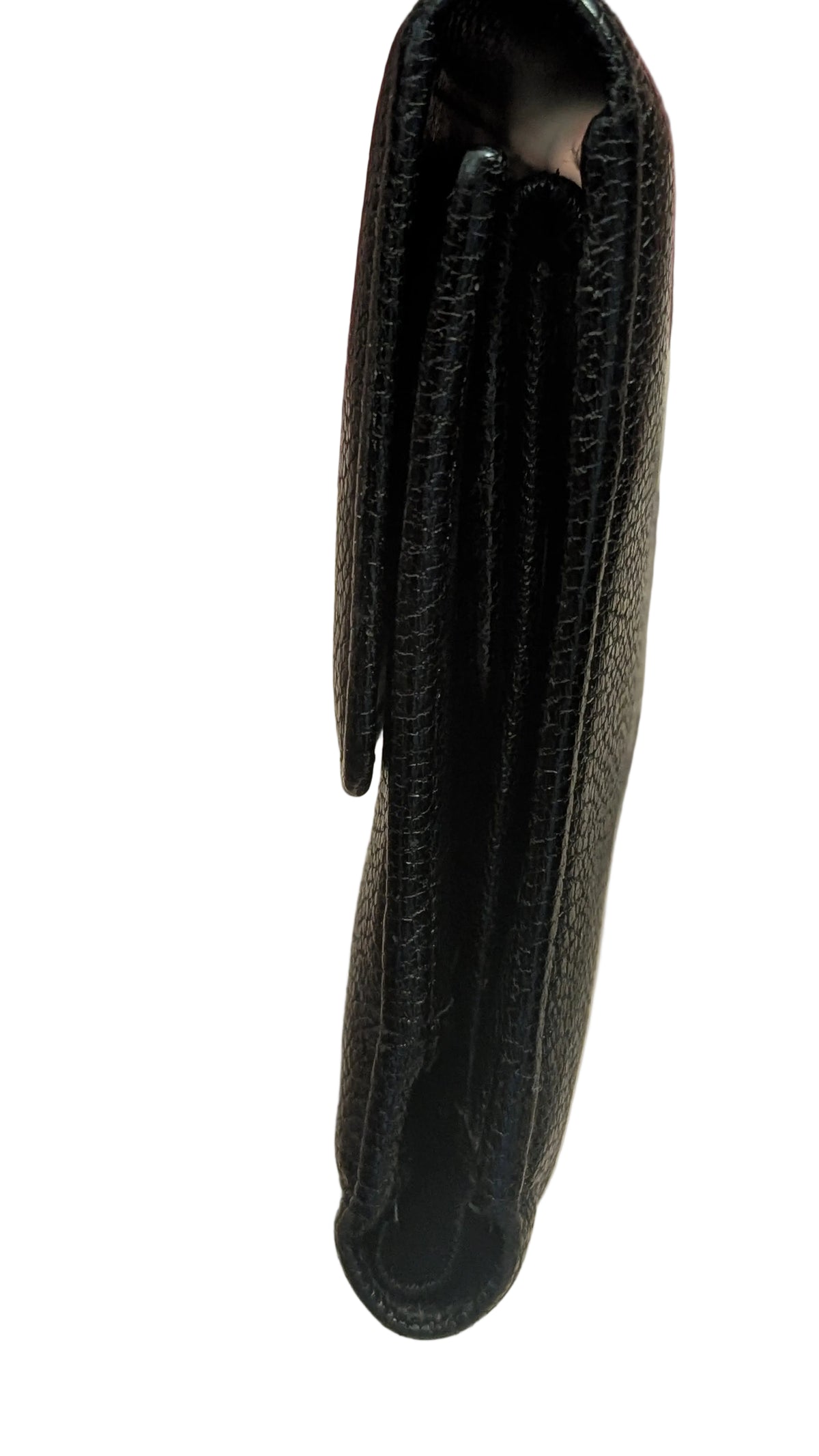A close-up of a black textured leather wallet being held by a hand, showing the side profile and interior compartments. A silver chain is visible in the blurred background. Pre-Owned Chanel Vintage Black Caviar Leather Wallet with Added Chain