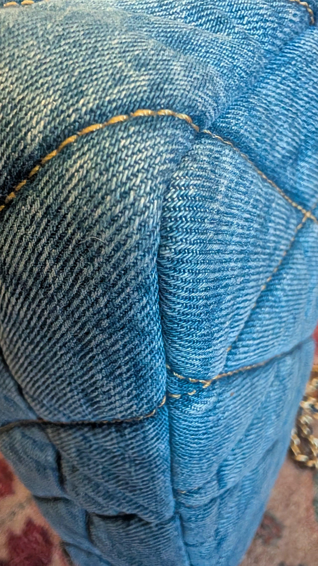 Close-up of a blue denim quilted fabric surface with visible stitching and texture. Pre-Owned Coach Quilted Tabby Shoulder Bag 26 – Blue Denim
