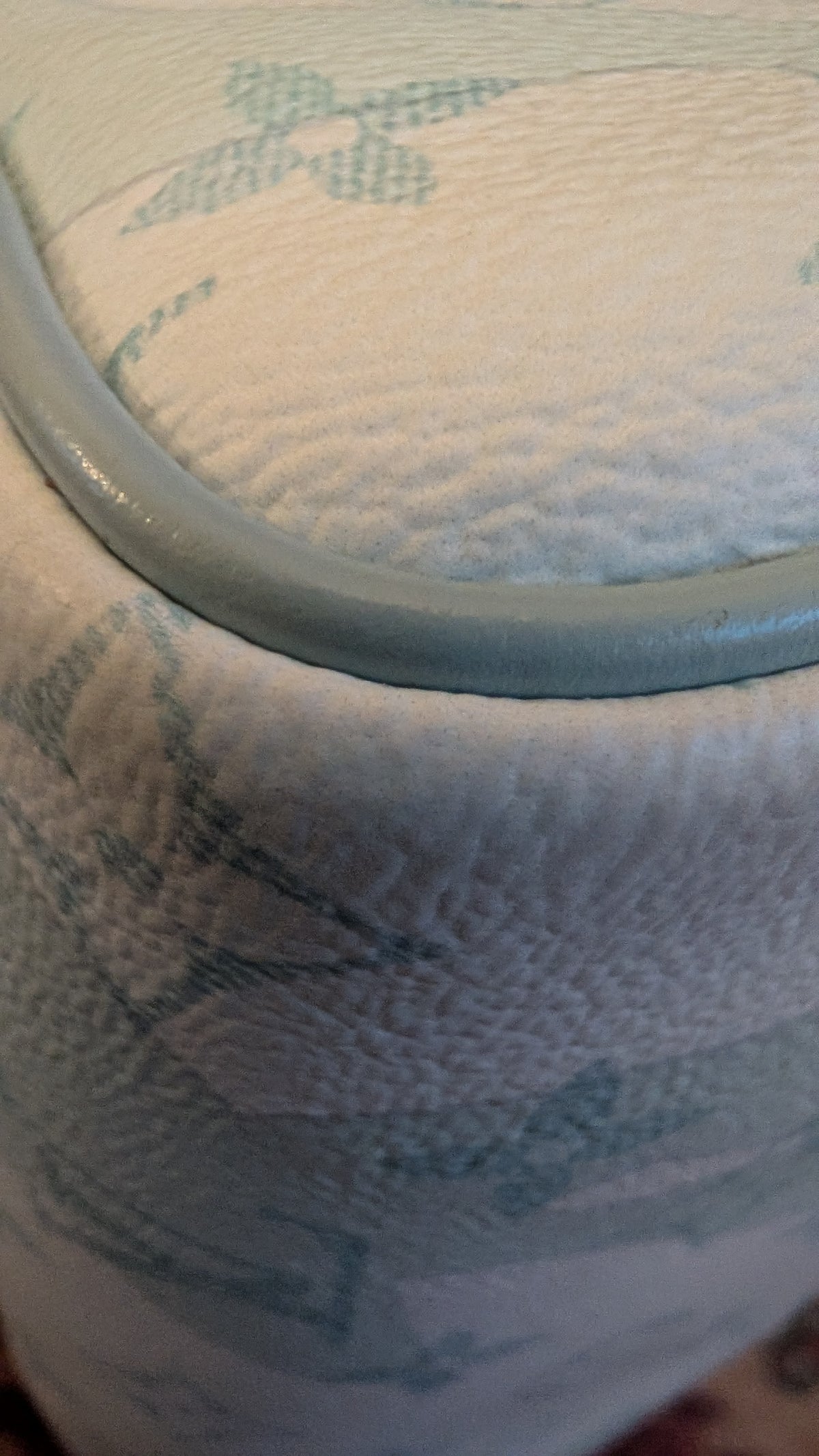 Close-up of a textured light blue and white patterned fabric with a smooth light blue trim along the edge. Pre-Owned Louis Vuitton x Richard Prince Limited Edition Monogram Bag – Spring/Summer 2008 – Pale Blue