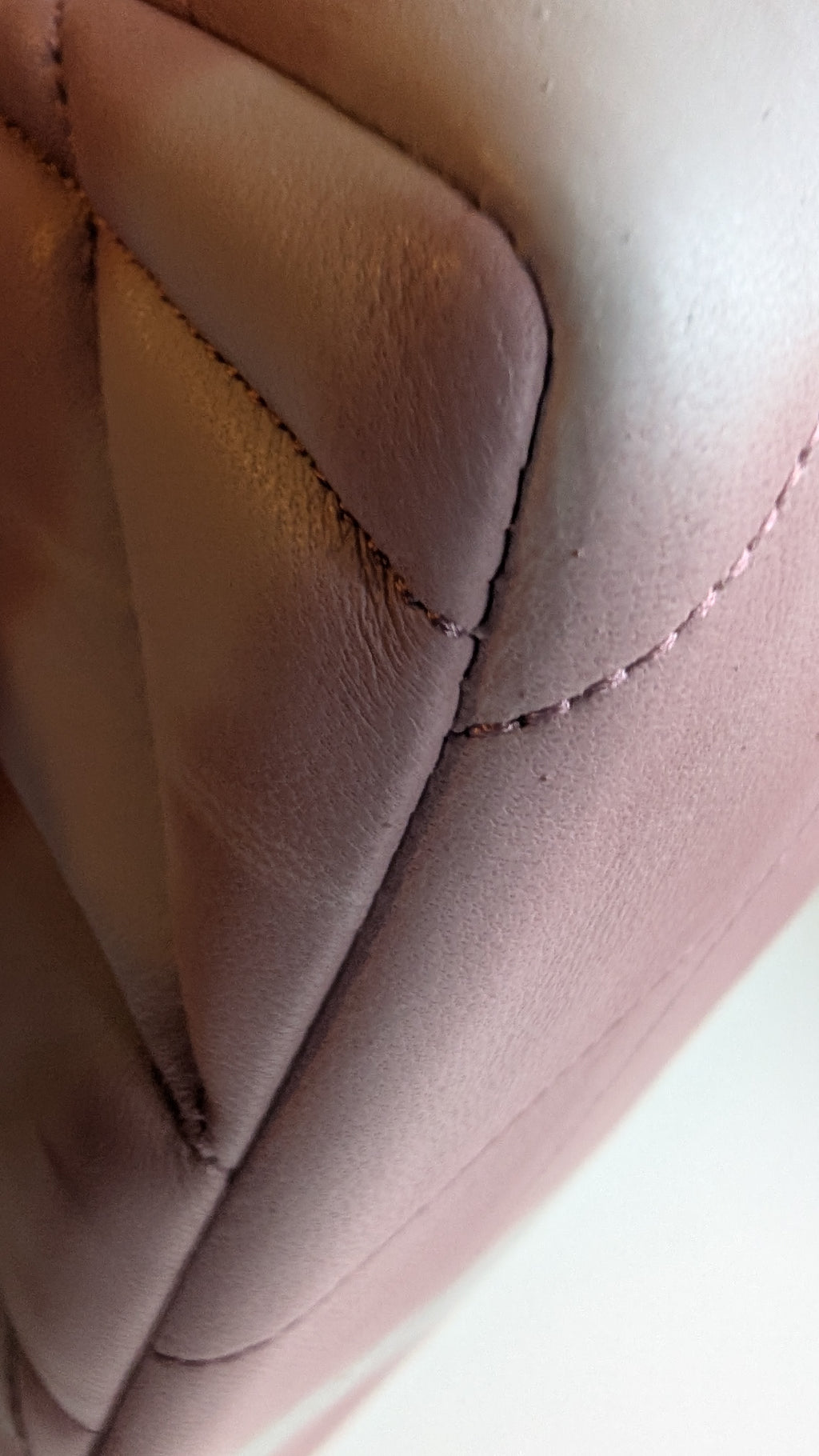 Close-up of a quilted leather surface in a pink  tone, showing stitched paneling and leather texture.  Pre-Owned Coach Tabby 20 Quilted Nappa Leather Shoulder Bag – Pink & White Ombré