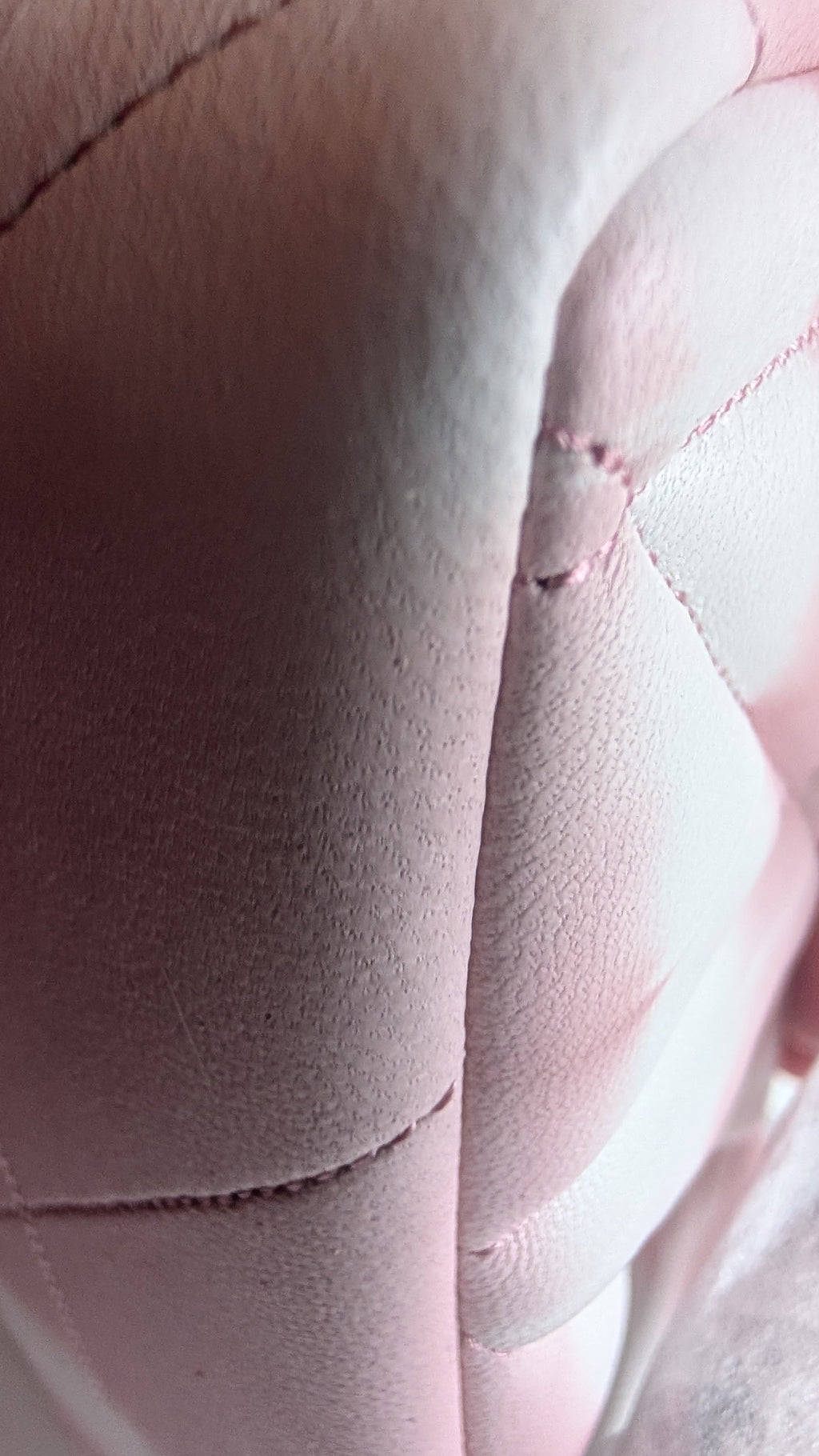 Close-up of a pink quilted leather or faux leather surface with visible stitching and a small defect or seam imperfection. Pre-Owned Coach Tabby 20 Quilted Nappa Leather Shoulder Bag – Pink & White Ombré