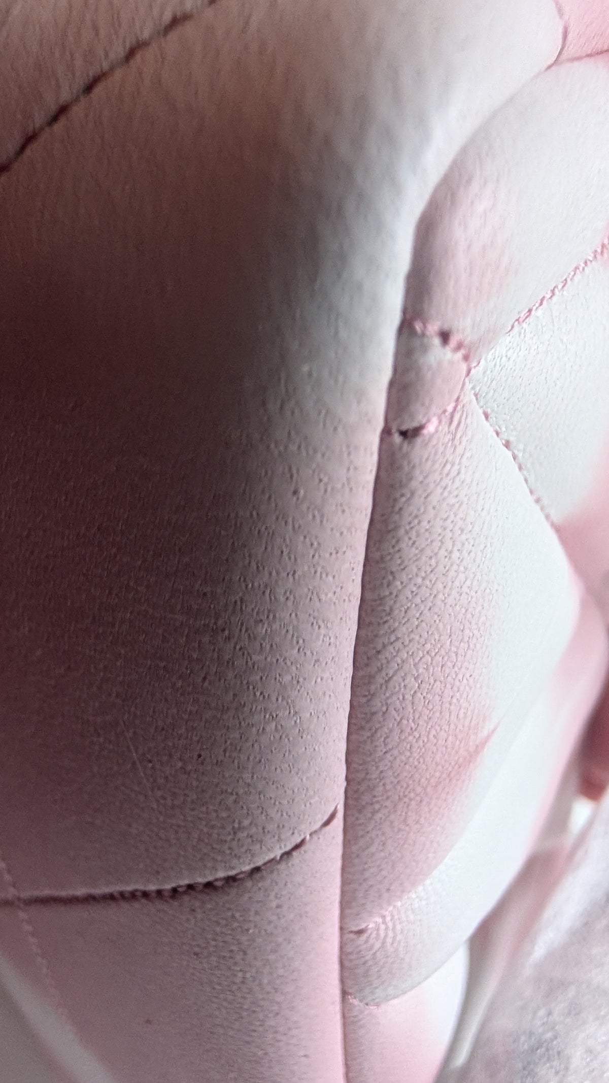 Close-up of a pink quilted leather or faux leather surface with visible stitching and a small defect or seam imperfection. Pre-Owned Coach Tabby 20 Quilted Nappa Leather Shoulder Bag – Pink & White Ombré