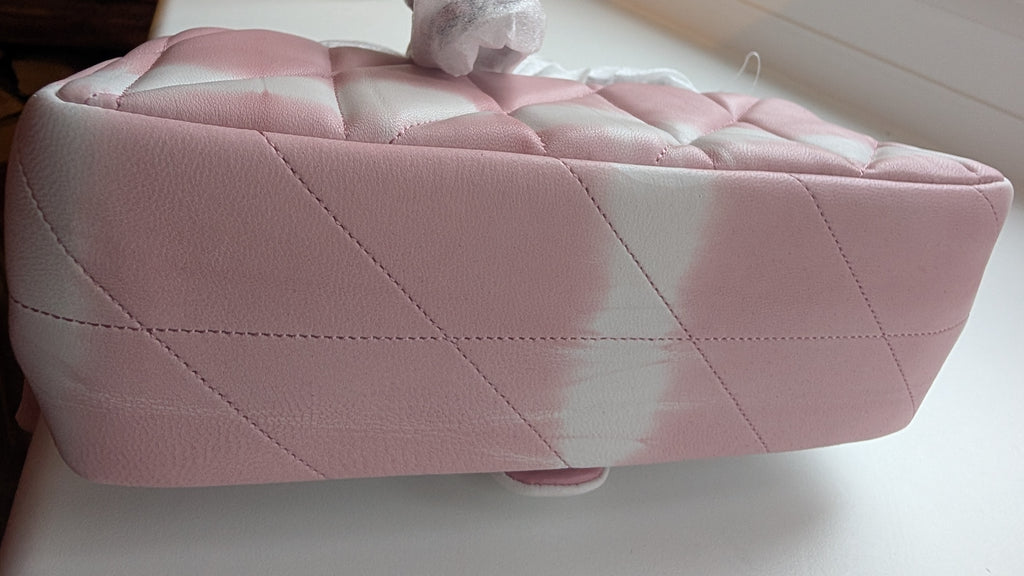 A pink quilted leather cosmetic bag or vanity box with a diamond-stitched pattern, shown from a side angle on a white surface. Pre-Owned Coach Tabby 20 Quilted Nappa Leather Shoulder Bag – Pink & White Ombré